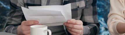 Person holding paper utility bill
