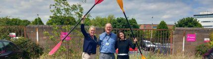 Frank and Parkinson's Ireland staff raise paddles ahead of the challenge
